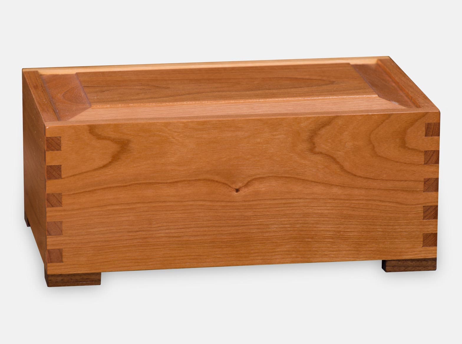 Wooden Cremation Urn. Cherry wood with Black Walnut feet. Box joint construction. Environment friendly oil finish. Laser engraving. Made by Quintessential Canada Inc.